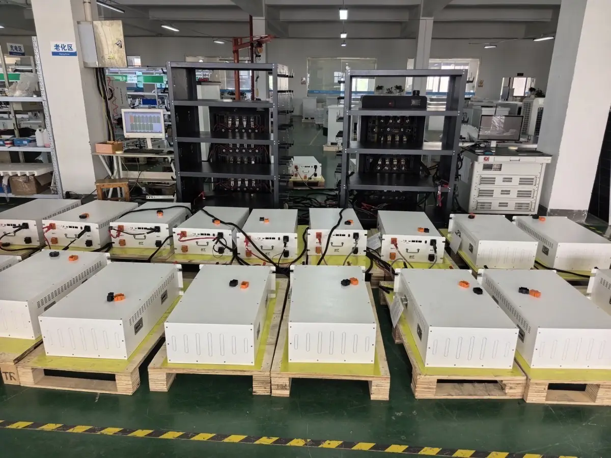 Weltrus C&I ESS factory floor showing battery modules on pallets, aging racks, and test monitors