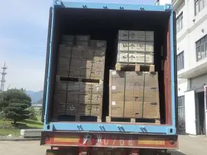 ** Open container at a Weltrus China factory loaded with lithium-ion battery crates and marked cartons