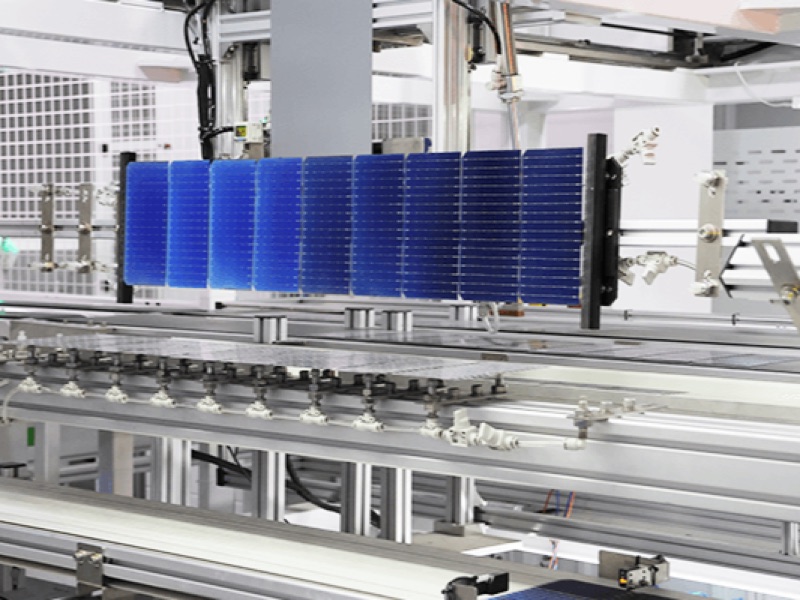 Solar cell string held on a transfer fixture above the module line