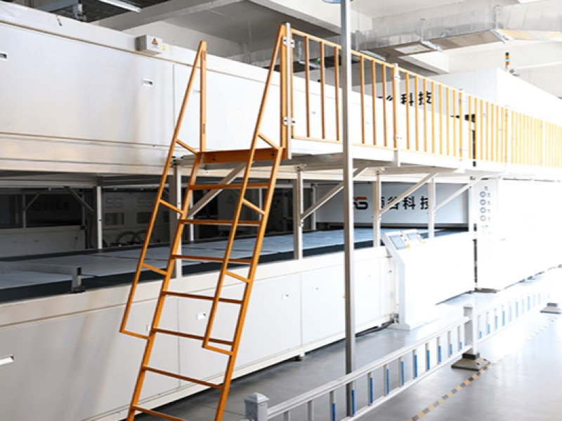 Solar module laminator with operator stairs and a floor-level control panel
