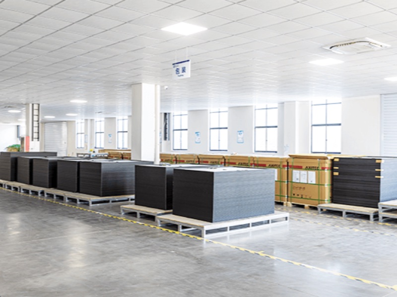Finished solar modules stacked on pallets in the factory packing zone