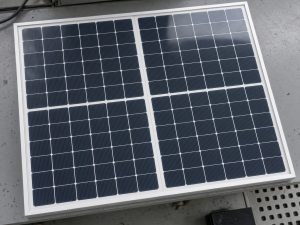 ** Unmarked half-cut solar module lying on a factory inspection table