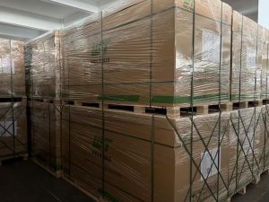 ** Double-stacked Weltrus solar module pallets staged in the factory warehouse for container loading